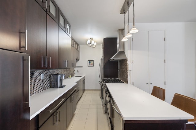 60 E 8th St Unit 11D, New York City, NY 10003 - kitchen featuring stainless steel appliances, wall chimney range hood, decorative backsplash, dark brown cabinetry, and light countertops