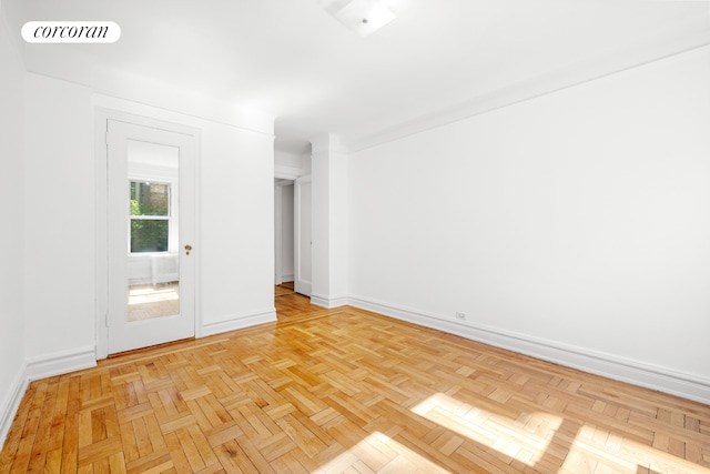 unfurnished room with visible vents and baseboards