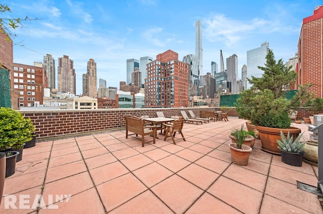 view of patio with a city view and outdoor dining area