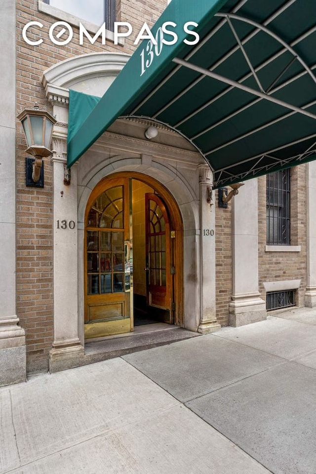 property entrance featuring brick siding