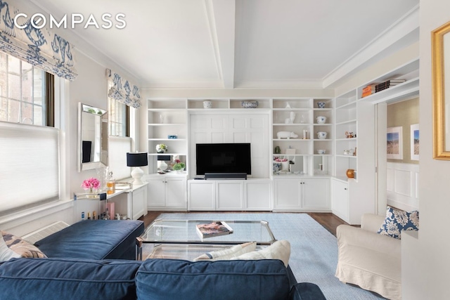 130 E 94th St Unit 1A, New York City, NY 10128 - living area featuring dark wood-style floors, built in features, beamed ceiling, ornamental molding, and a fireplace