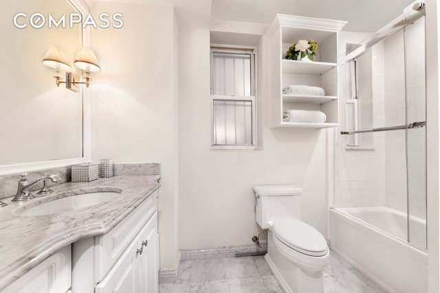 full bath with shower / bath combination with glass door, vanity, toilet, marble finish floor, and baseboards