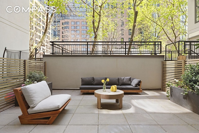view of patio featuring fence and outdoor lounge area