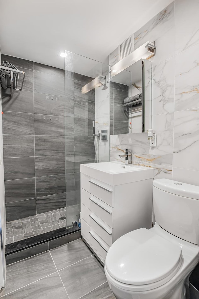 45 Tudor City Pl Unit 507, New York City, NY 10017 - bathroom with vanity, a walk in shower, and tile walls