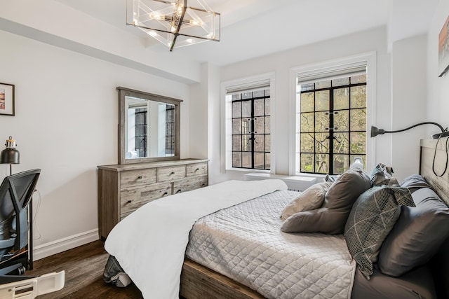 45 Tudor City Pl Unit 507, New York City, NY 10017 - bedroom featuring baseboards, dark wood-style flooring, and a chandelier