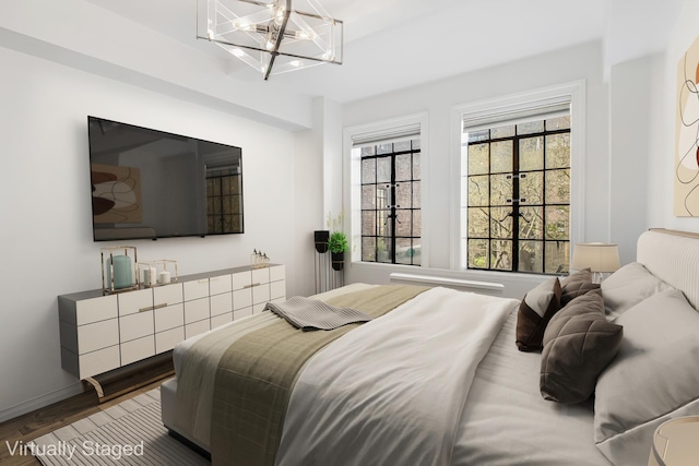 45 Tudor City Pl Unit 507, New York City, NY 10017 - bedroom featuring wood finished floors and a chandelier