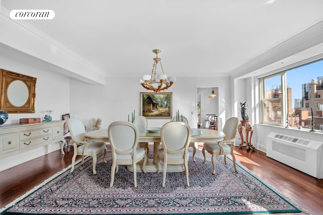 535 E 86th St Unit 21B, New York City, NY 10028 - dining area with a chandelier, crown molding, wood finished floors, radiator heating unit, and a city view