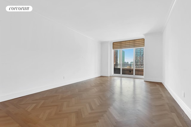 spare room with baseboards, ornamental molding, and visible vents