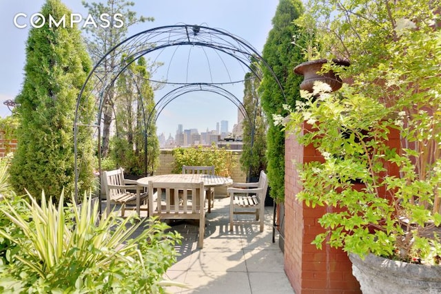 view of patio / terrace with a city view and outdoor dining space