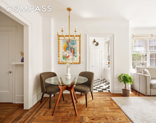 dining space featuring crown molding and baseboards