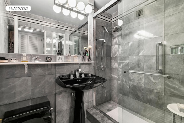 200 E 57th St Unit 14F, New York City, NY 10022 - full bathroom featuring a shower stall and tile walls