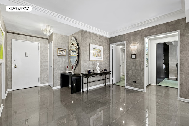 foyer featuring crown molding, visible vents, baseboards, a chandelier, and granite finish floor