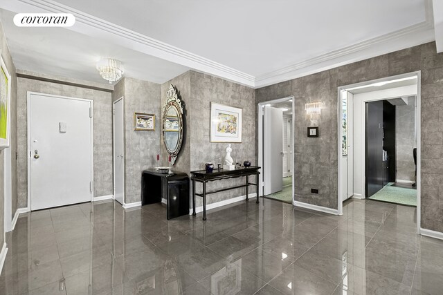 200 E 57th St Unit 14F, New York City, NY 10022 - foyer entrance with baseboards, crown molding, a chandelier, and granite floors