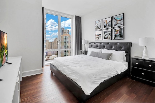60 Riverside Blvd Unit 2801, New York City, NY 10069 - bedroom featuring dark wood-type flooring, a city view, floor to ceiling windows, and baseboards