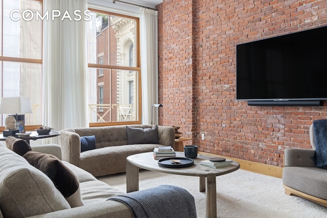 living area featuring brick wall