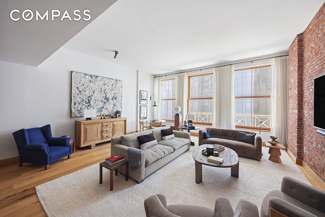 living room featuring baseboards and wood finished floors