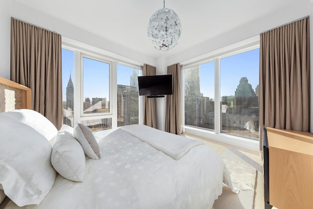 bedroom featuring a chandelier and multiple windows