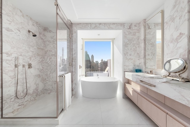 bathroom with vanity, a marble finish shower, and a freestanding tub