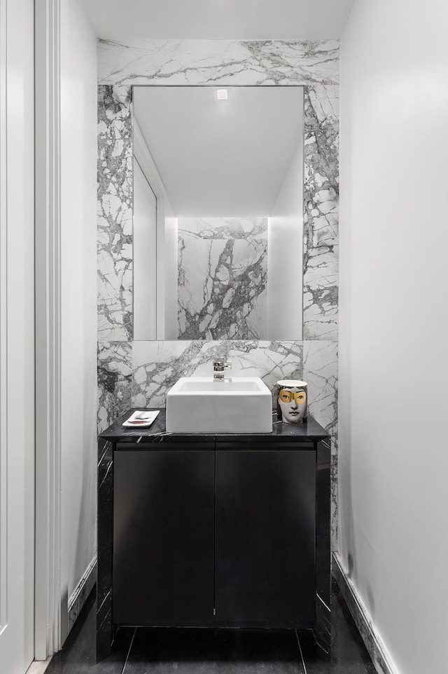 bathroom with backsplash, tile walls, and vanity