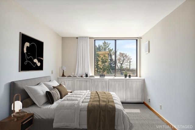 carpeted bedroom featuring baseboards