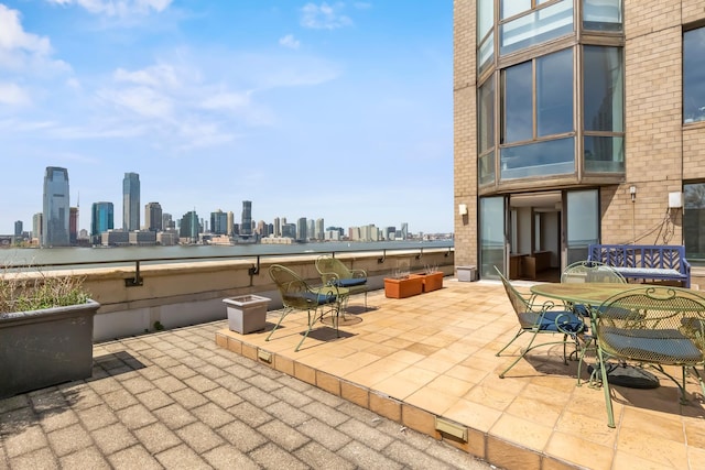 view of patio with a city view and outdoor dining space