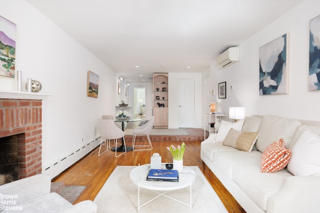 living room featuring a wall mounted AC, baseboard heating, a brick fireplace, wood finished floors, and recessed lighting