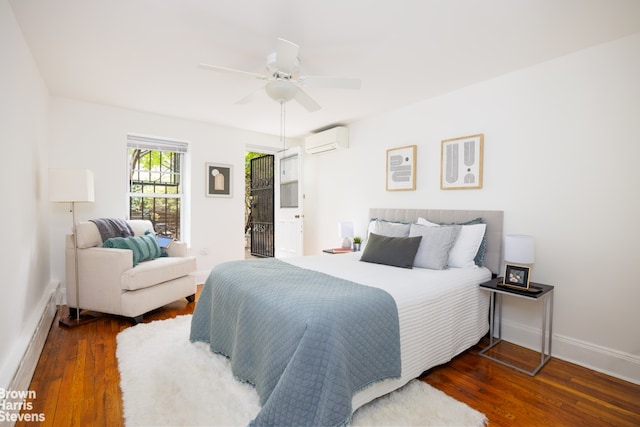 bedroom featuring a ceiling fan, baseboards, wood finished floors, a baseboard radiator, and a wall mounted AC