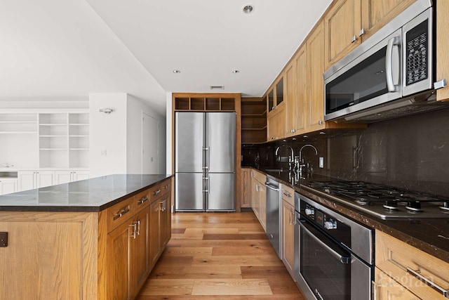 333 Rector Pl Unit 805, New York City, NY 10280 - kitchen with stainless steel appliances, light wood-type flooring, tasteful backsplash, dark stone countertops, and open shelves