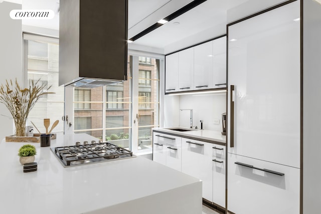70 Charlton St Unit 2G, New York City, NY 10014 - kitchen with white built in refrigerator, stainless steel gas stovetop, white cabinetry, and modern cabinets