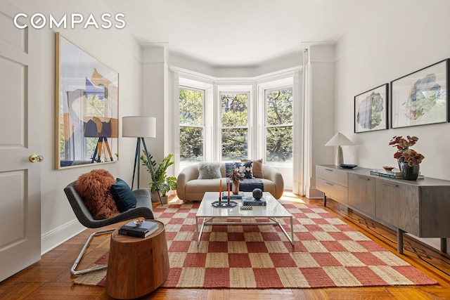 living area featuring baseboards