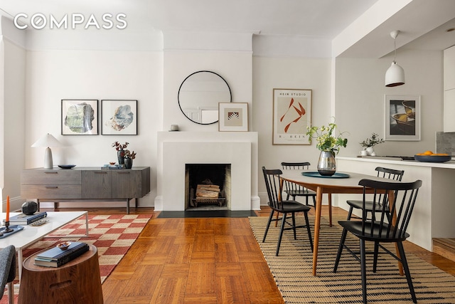 living area with a fireplace with flush hearth