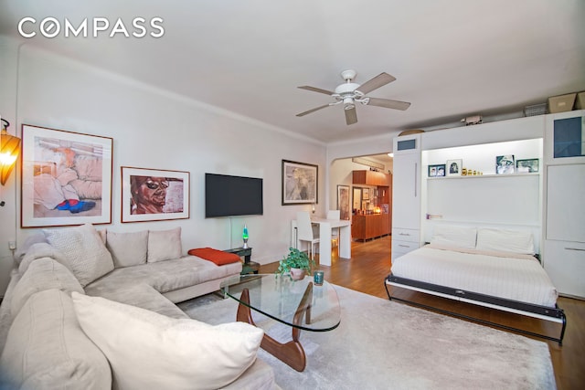 living room featuring a ceiling fan and wood finished floors