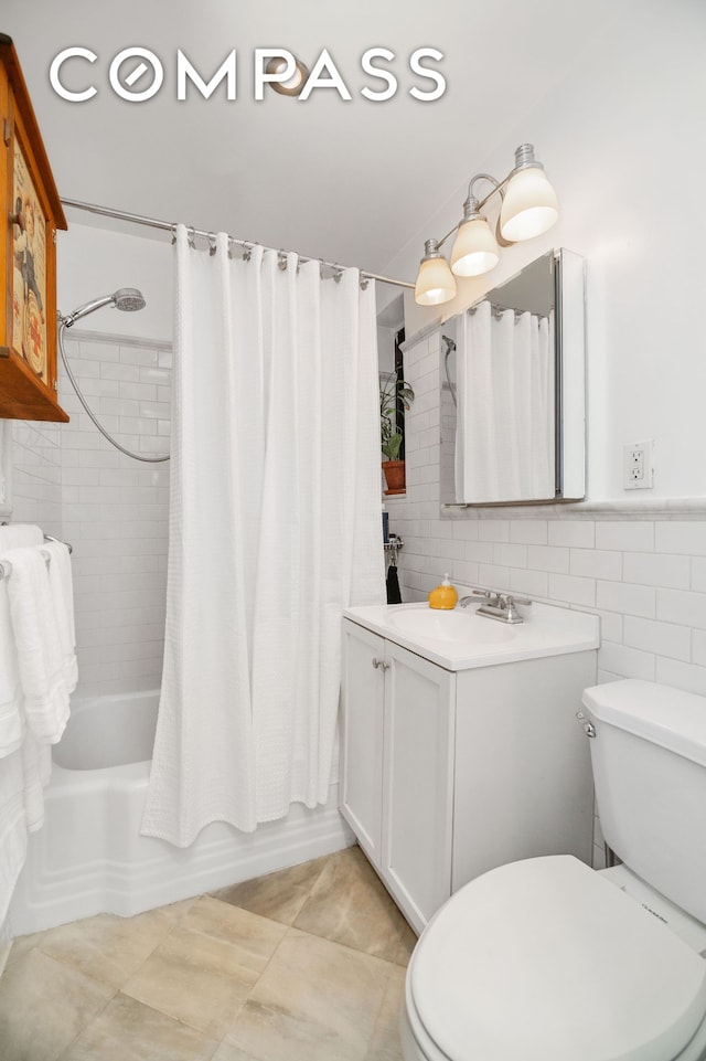 bathroom with shower / tub combo with curtain, toilet, and tile walls
