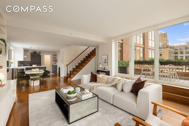 living room featuring wood finished floors and stairway