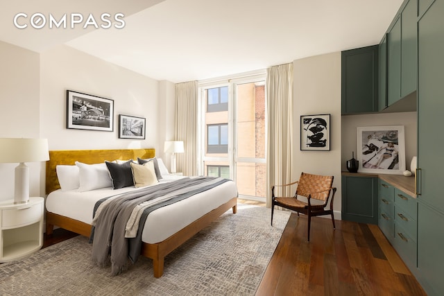 bedroom featuring baseboards and dark wood-style floors