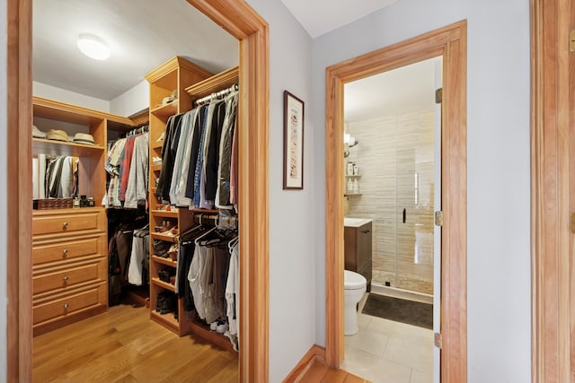 spacious closet featuring light wood-style floors