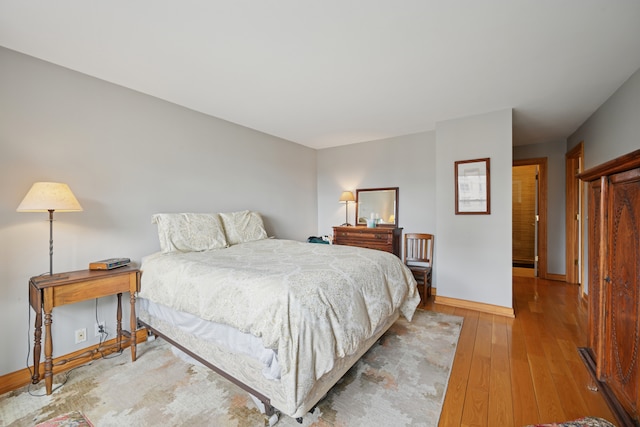 bedroom with baseboards and wood-type flooring