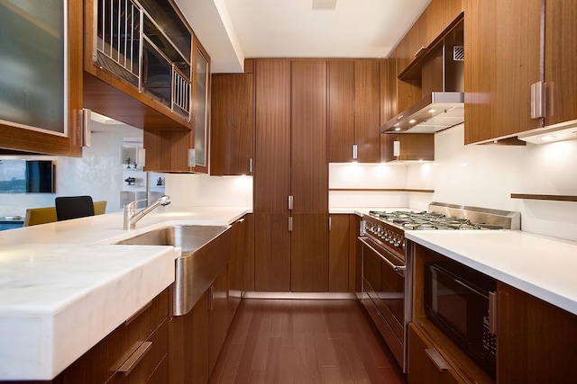 60 Riverside Blvd Unit 1502, New York City, NY 10069 - kitchen with black microwave, dark wood-type flooring, high end stove, light countertops, and wall chimney exhaust hood