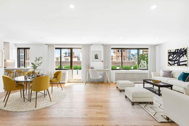 living room with recessed lighting, radiator, and light wood-style floors