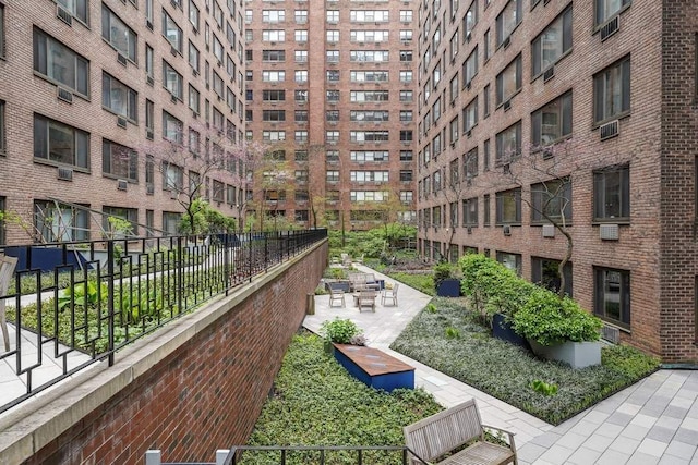 view of community featuring a patio and fence