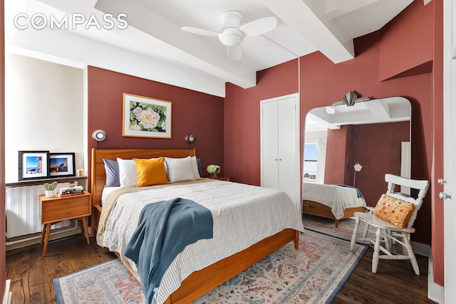 bedroom with arched walkways, beamed ceiling, a ceiling fan, and wood finished floors