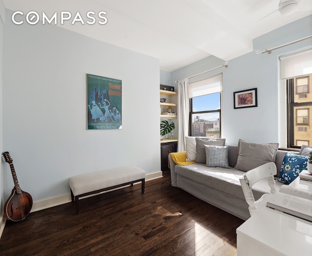 living room featuring baseboards and dark wood finished floors