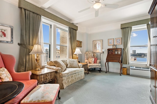 living area featuring carpet floors, baseboards, and a ceiling fan