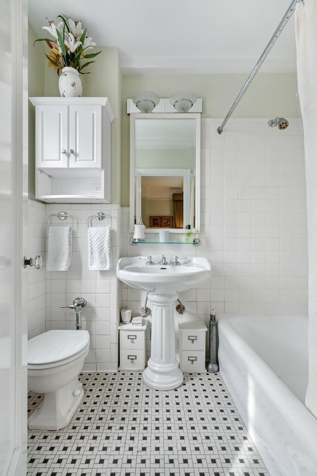 515 W End Ave Unit 15-D, New York City, NY 10024 - bathroom featuring tile walls, shower / tub combo, tile patterned flooring, and toilet