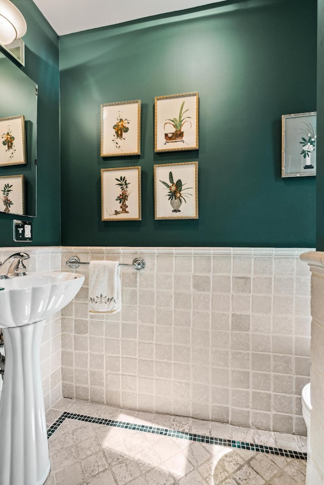 515 W End Ave Unit 15-D, New York City, NY 10024 - half bathroom with toilet, tile walls, and wainscoting