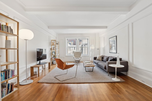 515 W End Ave Unit 15-D, New York City, NY 10024 - living area featuring beam ceiling, wood finished floors, and baseboards