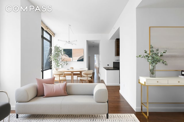 101 W 24th St Unit 5E, New York City, NY 10011 - living area featuring wood finished floors, a chandelier, and baseboards