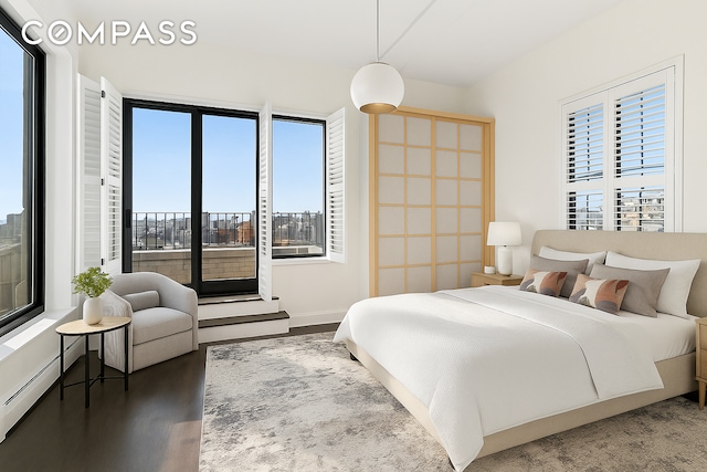 bedroom featuring multiple windows and wood finished floors
