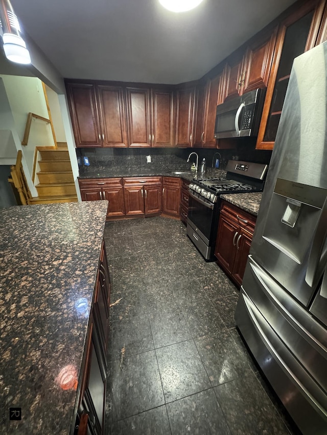 1264 E 73rd St, New York City, NY 11234 - kitchen featuring appliances with stainless steel finishes, backsplash, a sink, glass insert cabinets, and reddish brown cabinets