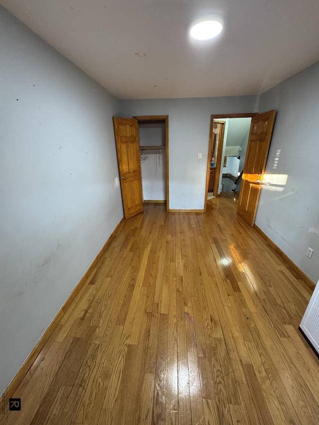 1264 E 73rd St, New York City, NY 11234 - unfurnished bedroom with hardwood / wood-style floors, baseboards, and a closet